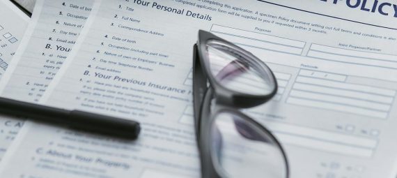 black framed eyeglasses on white paper